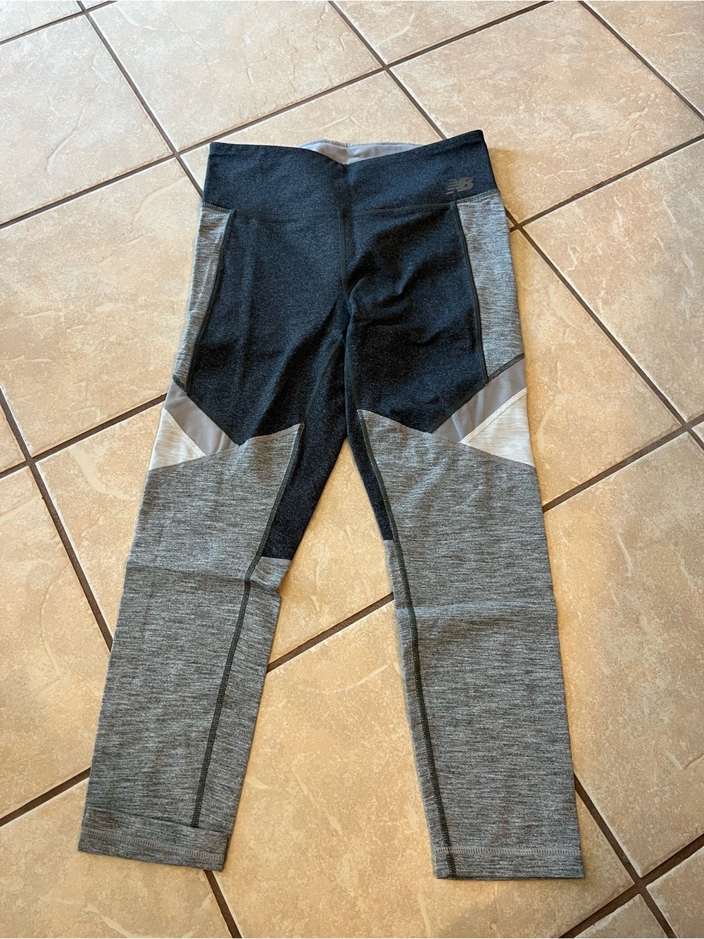 New balance women’s capris with side pockets, size medium - with mesh detailing.